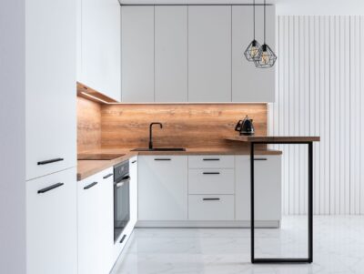 Cuisine en L moderne blanche et bois avec retour snack et four encastré